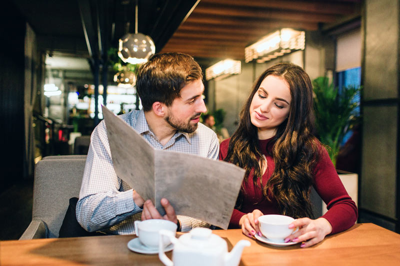 guests choosing food from a large menu. I is clearly a menu that is easy to look from the distance and clear